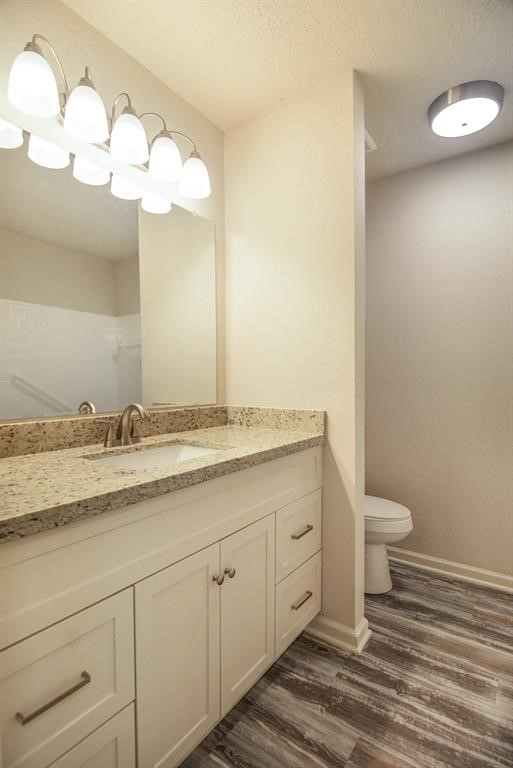 4615 Roserock Lane Spring, TX 77388 - Photo 14 of 21 a bathroom with a granite countertop sink and a toilet