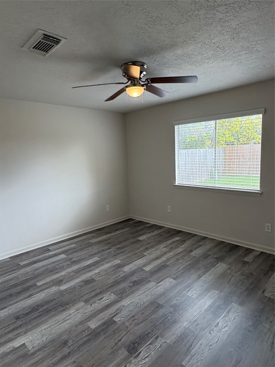 4615 Roserock Lane Spring, TX 77388 - Photo 16 of 21 an empty room with wooden floor and windows