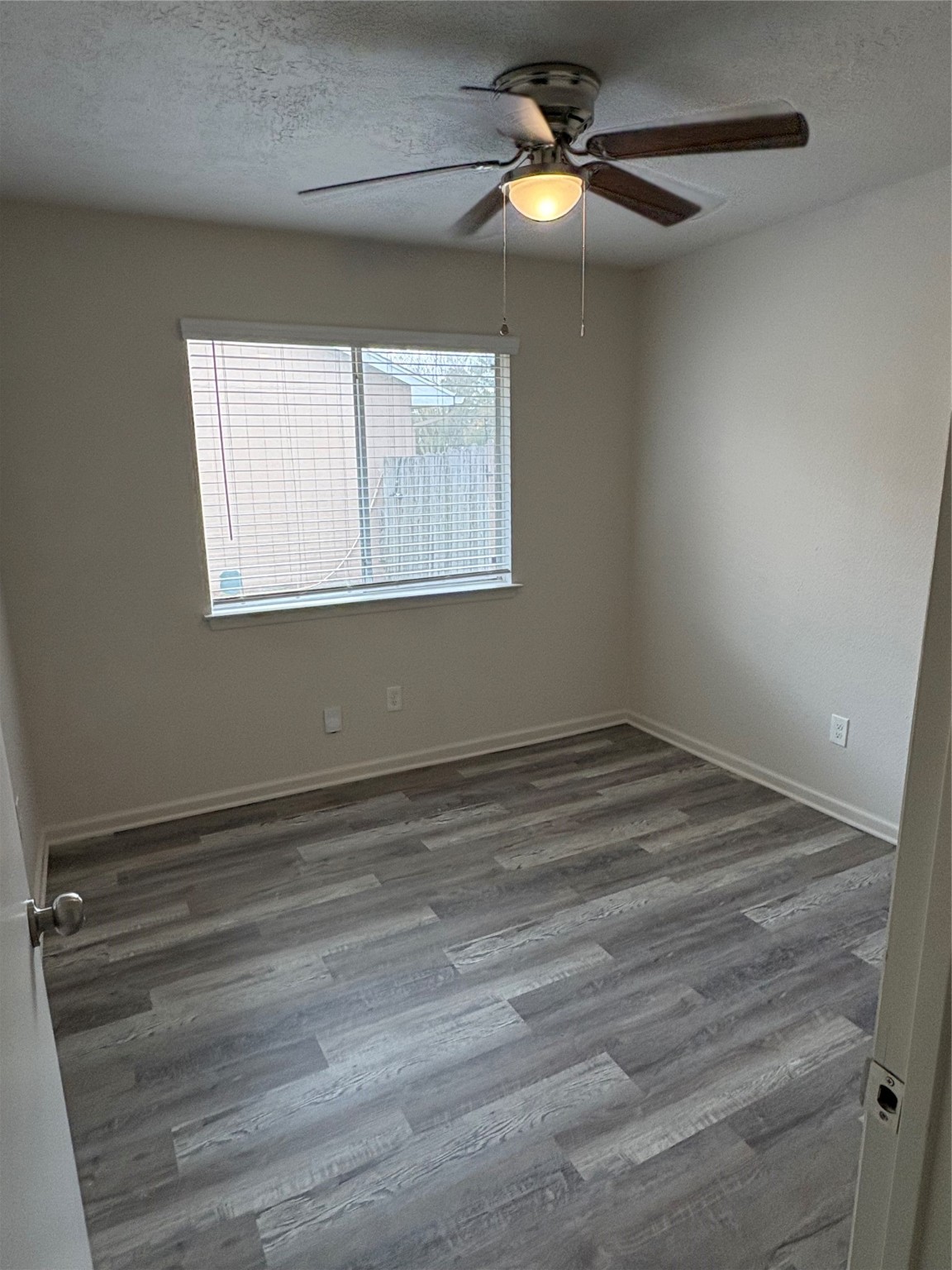 4615 Roserock Lane Spring, TX 77388 - Photo 17 of 21 an empty room with a window and ceiling fan