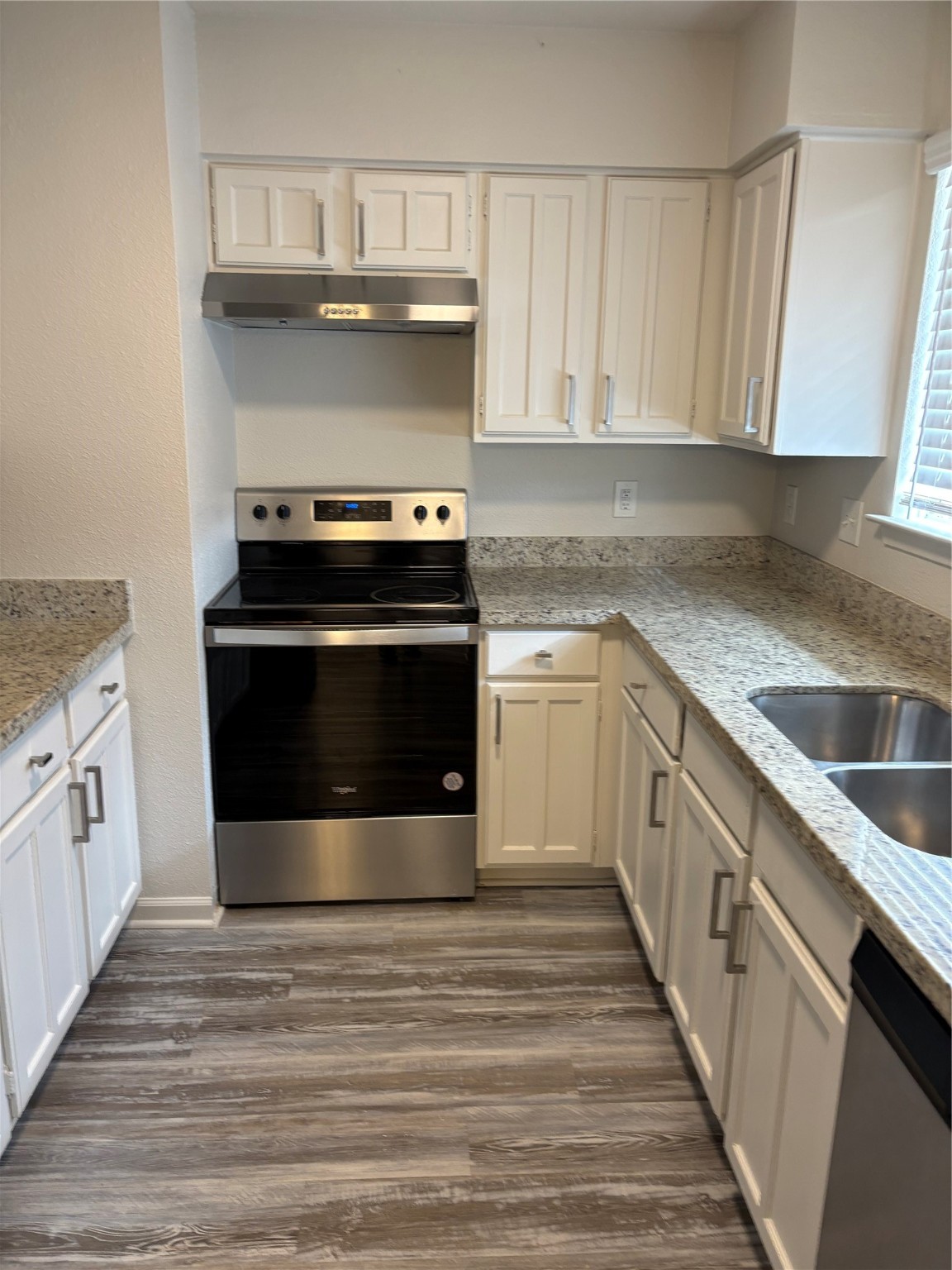 4615 Roserock Lane Spring, TX 77388 - Photo 4 of 21 a kitchen with a stove and white cabinets