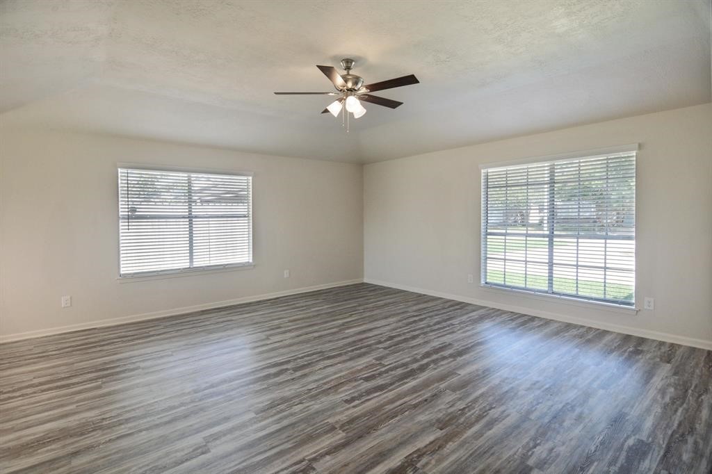 4615 Roserock Lane Spring, TX 77388 - Photo 8 of 21 a view of an empty room with wooden floor and a window