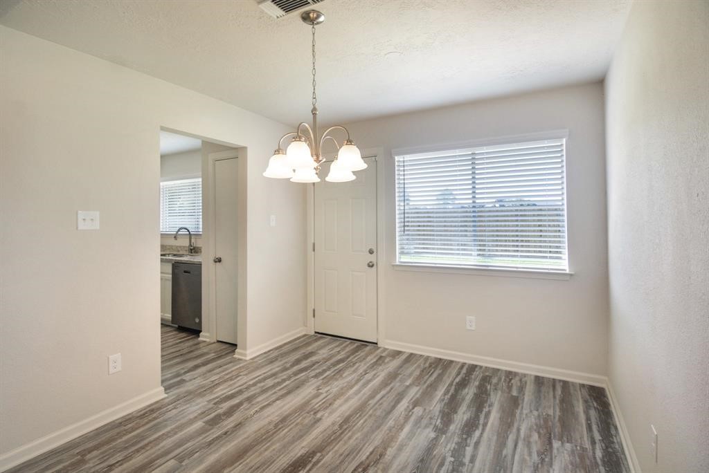 4615 Roserock Lane Spring, TX 77388 - Photo 10 of 21 a view of an empty room with a window and wooden floor