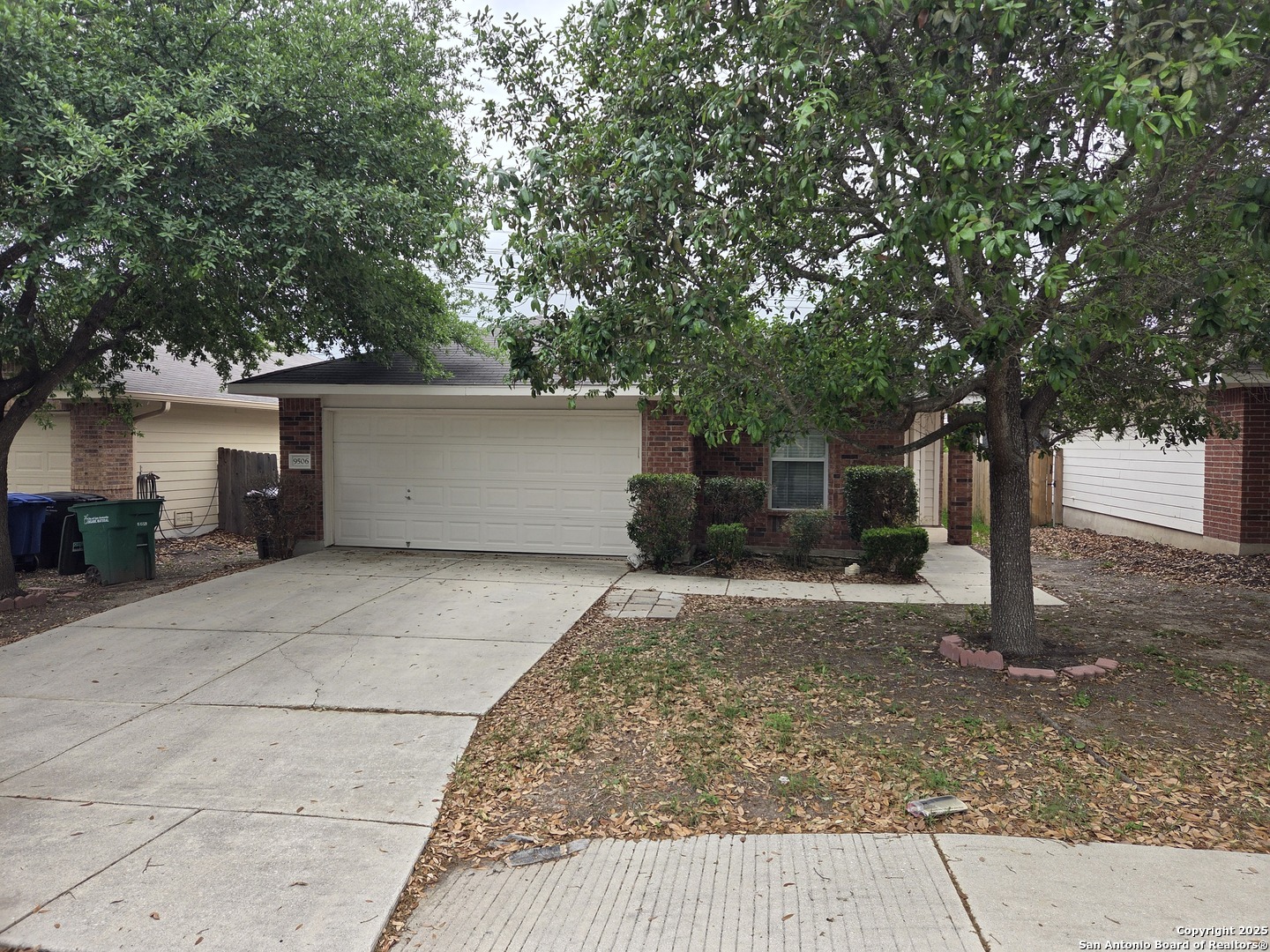 a front view of a house with a yard and a garage
