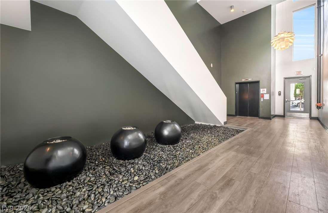 2775 West Pebble Road, Unit 505 Las Vegas, NV 89123 - Photo 24 of 26 Enter a modern lobby featuring a unique rock garden installation and plank flooring.