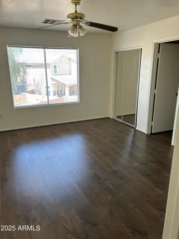 a spacious bathroom with a toilet sink and mirror
