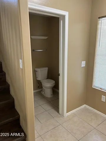 a bathroom with a toilet and a window