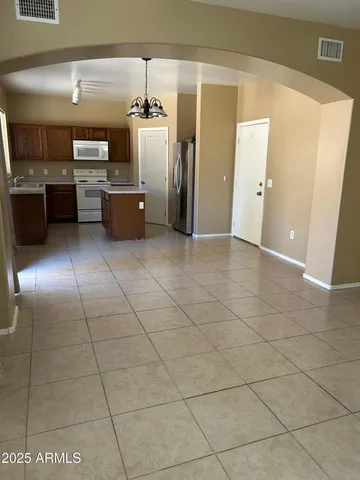 a kitchen with granite countertop a stove and cabinets