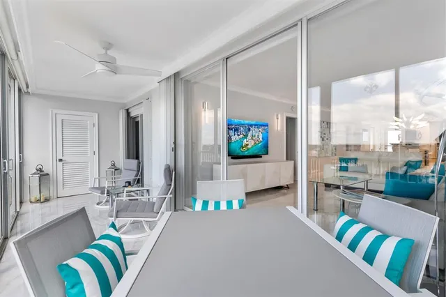 a living room with furniture and a floor to ceiling window