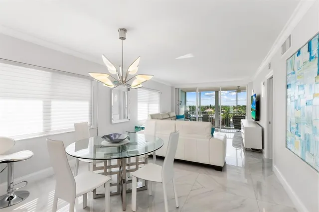 a living room with furniture a chandelier and a table