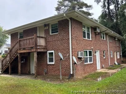 a view of a brick house with a sink and a window