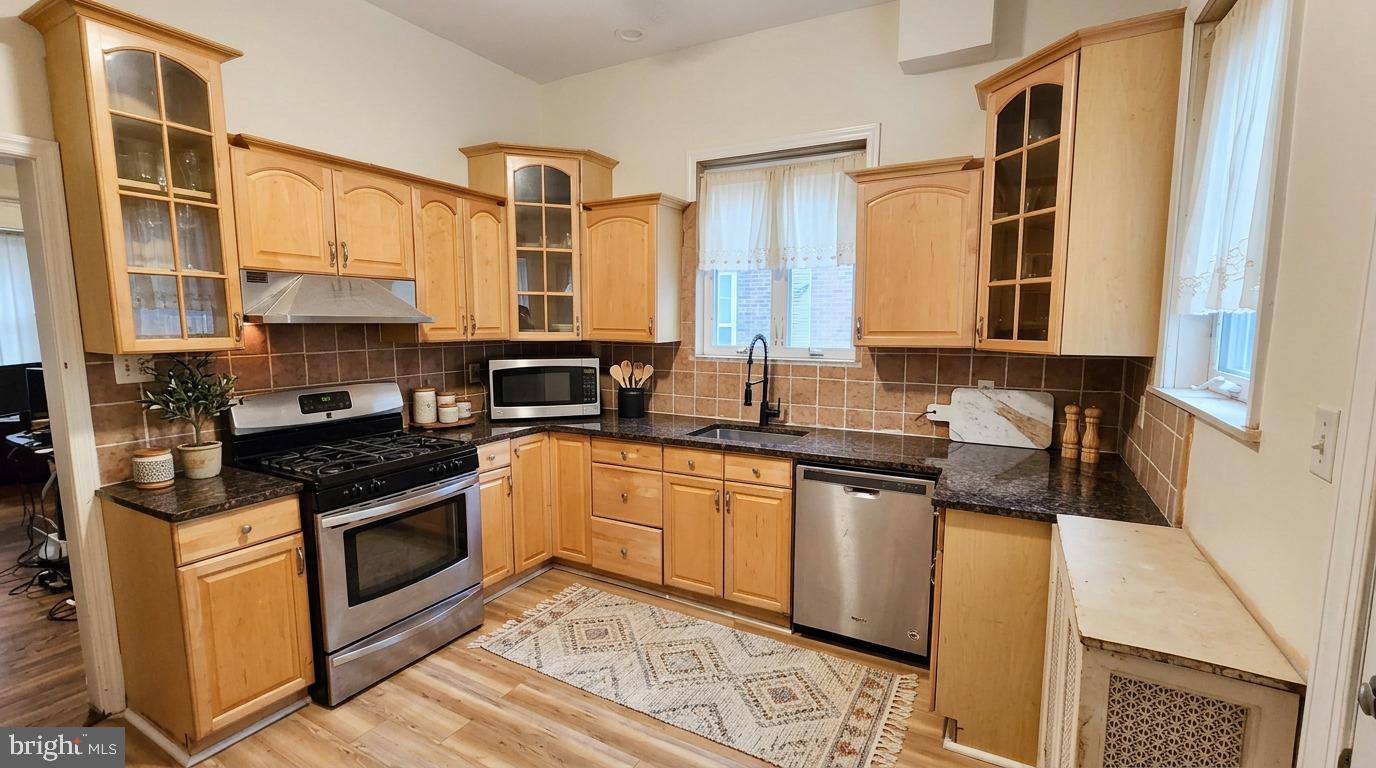 614 Wynnewood Road Philadelphia, PA 19151 - Photo 8 of 15 a kitchen with stainless steel appliances granite countertop a stove and a sink
