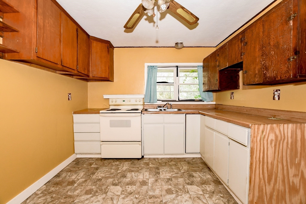 6 Gilbert Way Wareham, MA 02571 - Photo 17 of 41 a kitchen with granite countertop a sink window and cabinets