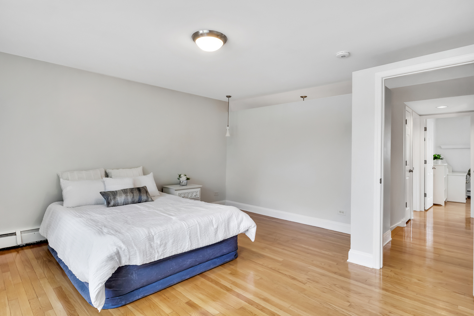 1341 Greenwillow Lane, Unit A Glenview, IL 60025 - Photo 15 of 27 a bedroom with a bed and wooden floor