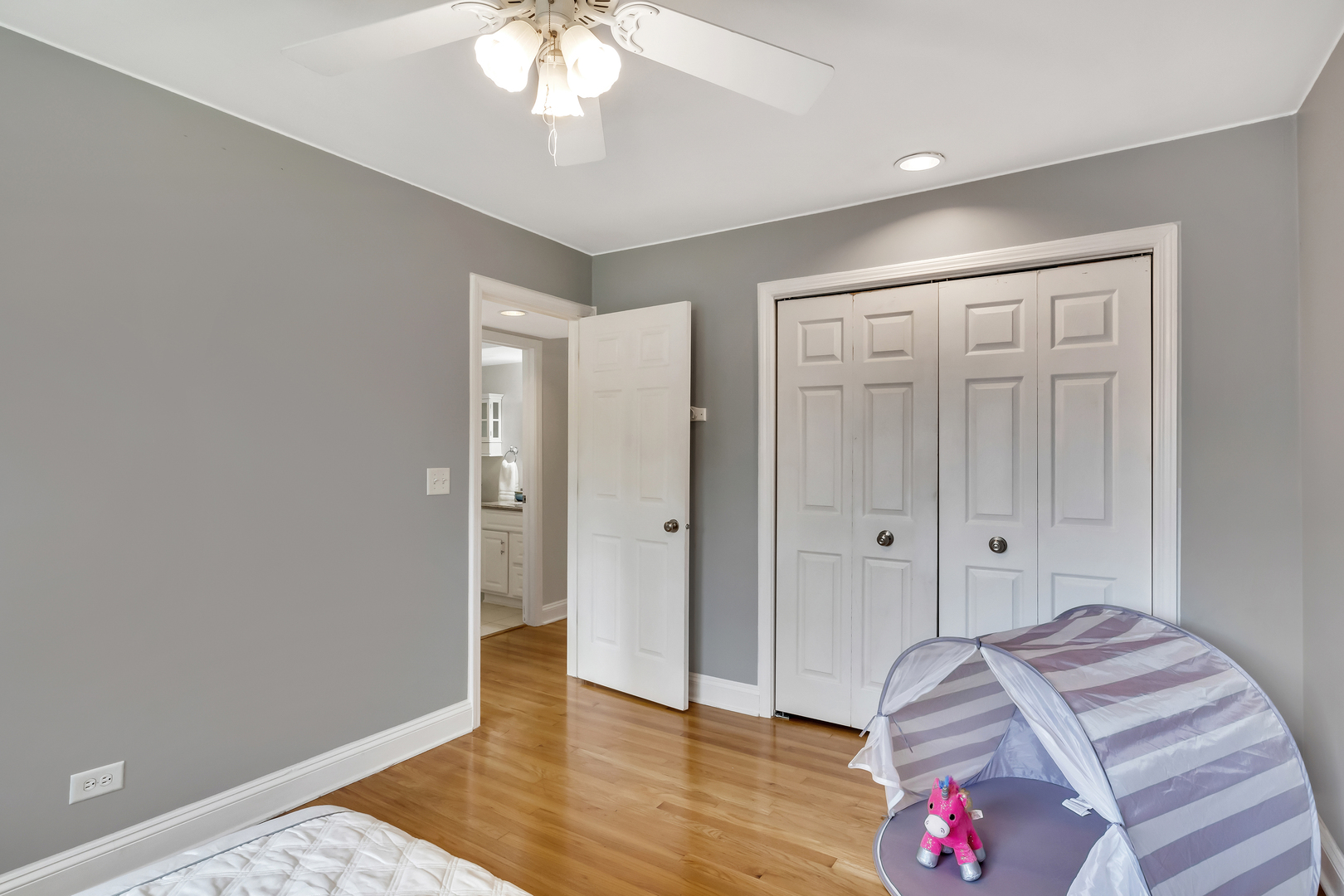 1341 Greenwillow Lane, Unit A Glenview, IL 60025 - Photo 19 of 27 a bedroom with a bed and a chandelier