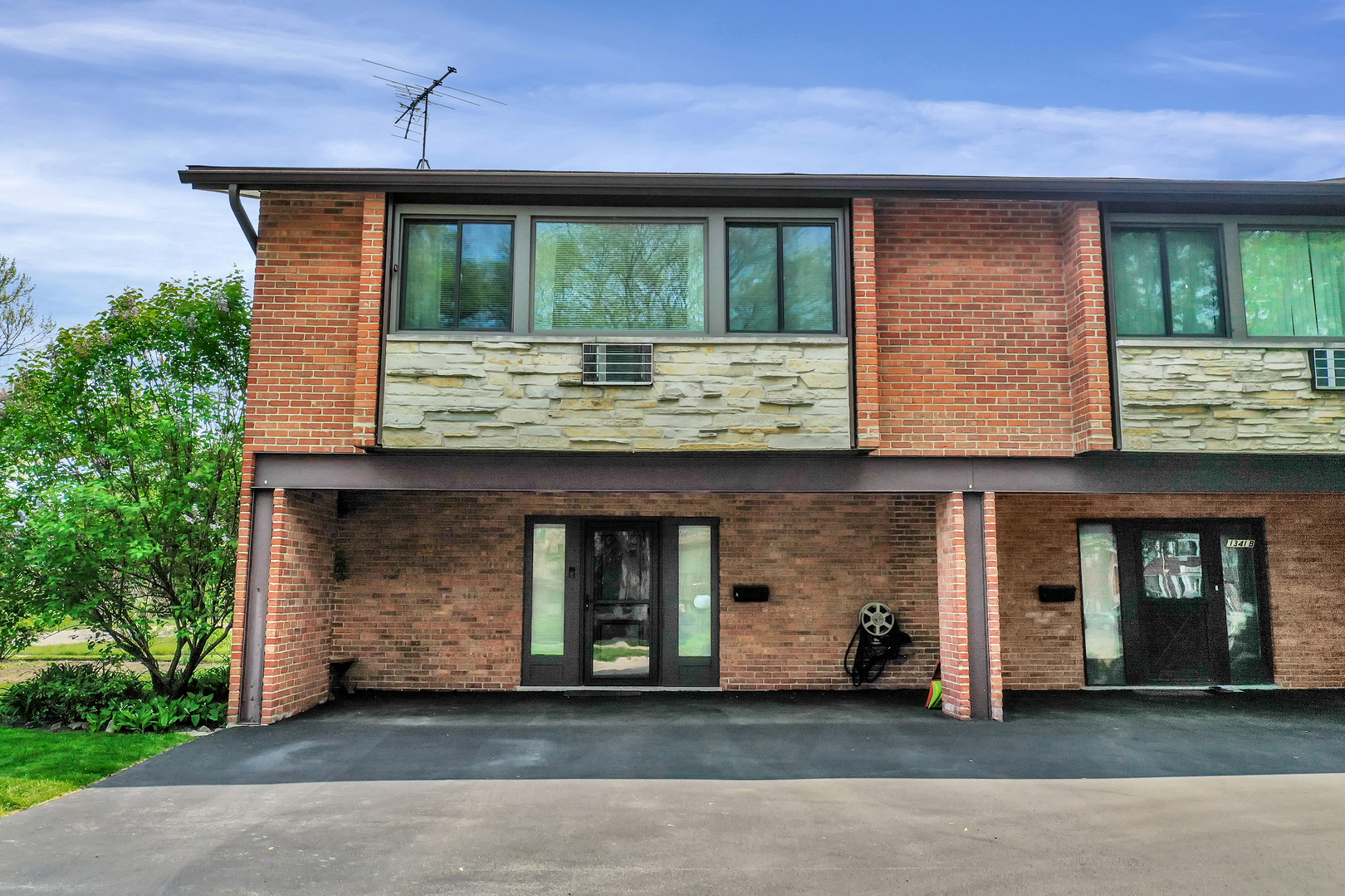 1341 Greenwillow Lane, Unit A Glenview, IL 60025 - Photo 2 of 27 a front view of a house with a yard