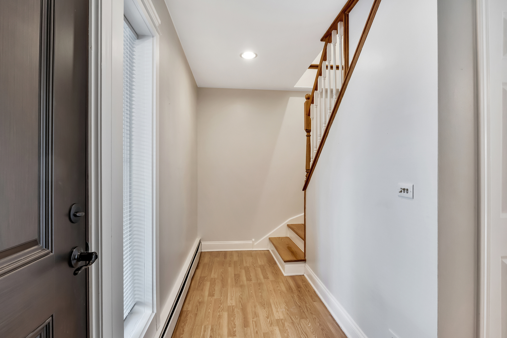 1341 Greenwillow Lane, Unit A Glenview, IL 60025 - Photo 3 of 27 a view of a hallway with wooden floor and staircase