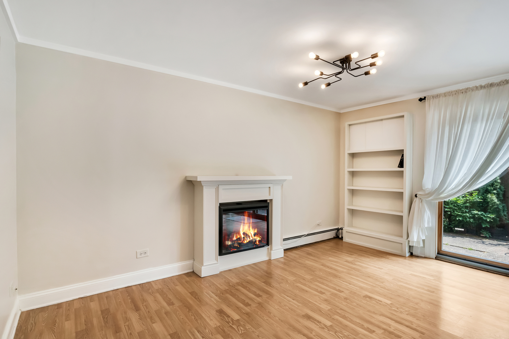 1341 Greenwillow Lane, Unit A Glenview, IL 60025 - Photo 7 of 27 a view of an empty room with a fireplace and cabinet