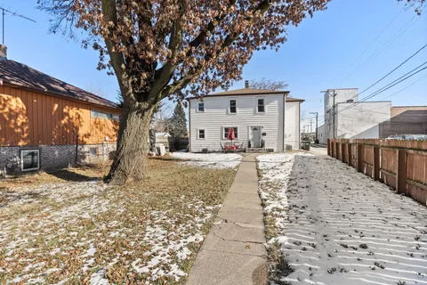 a view of a house with snow on the road