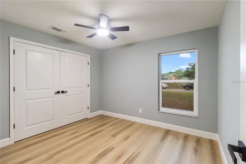 a bathroom with a toilet sink vanity tub and mirror
