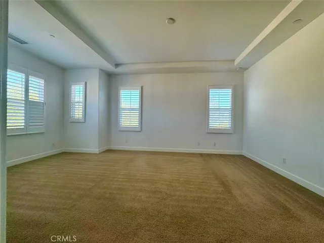 a view of an empty room with windows