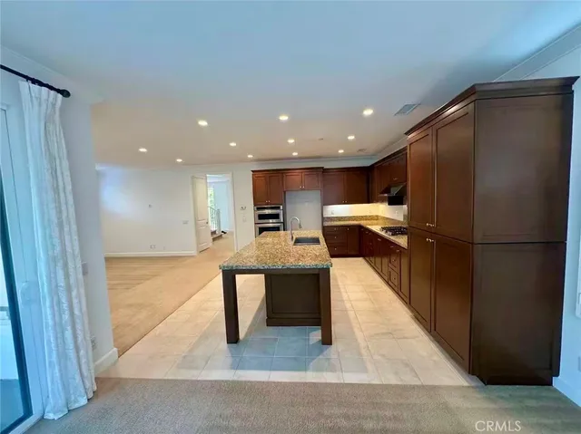 a view of kitchen with kitchen island wooden floor center island and stainless steel appliances