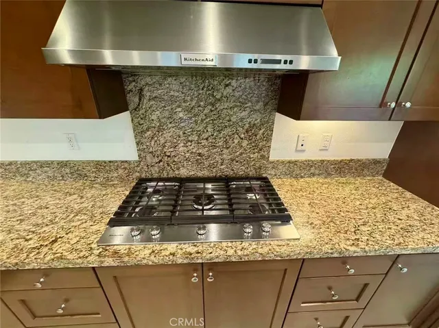 a white stove top oven sitting inside of a kitchen