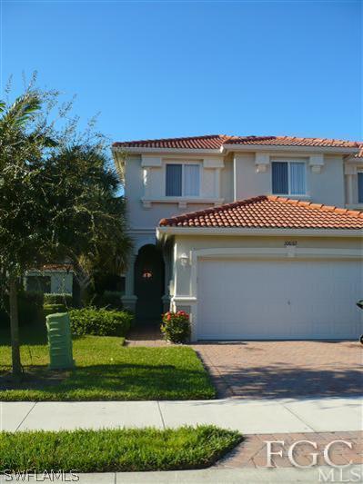 10032 Ravello Boulevard Fort Myers, FL 33905 - Photo 1 of 1 a front view of a house with a yard