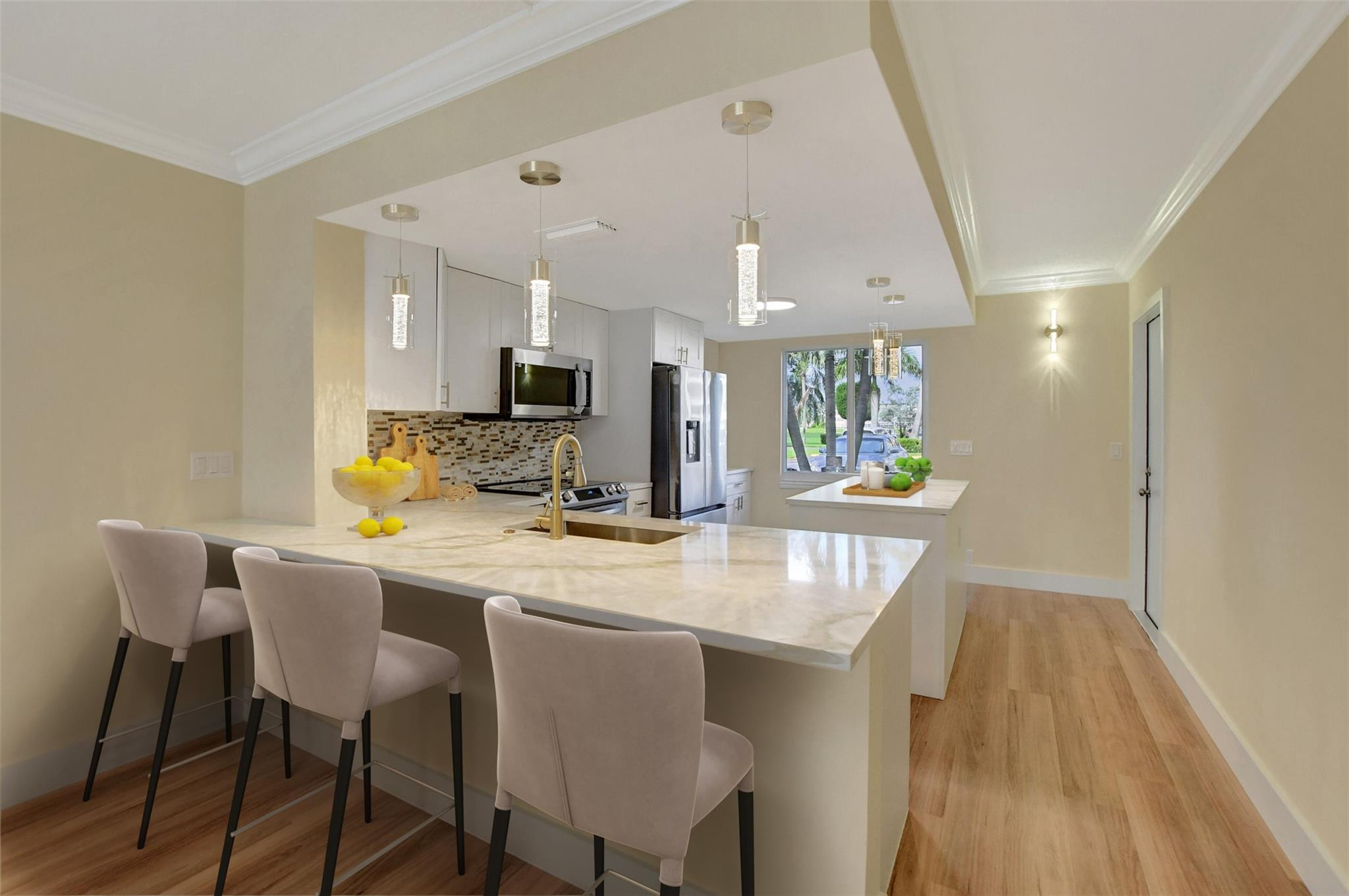 1019 Guildford East, Unit 1019 Boca Raton, FL 33434 - Photo 16 of 38 a kitchen with a table and chairs in it