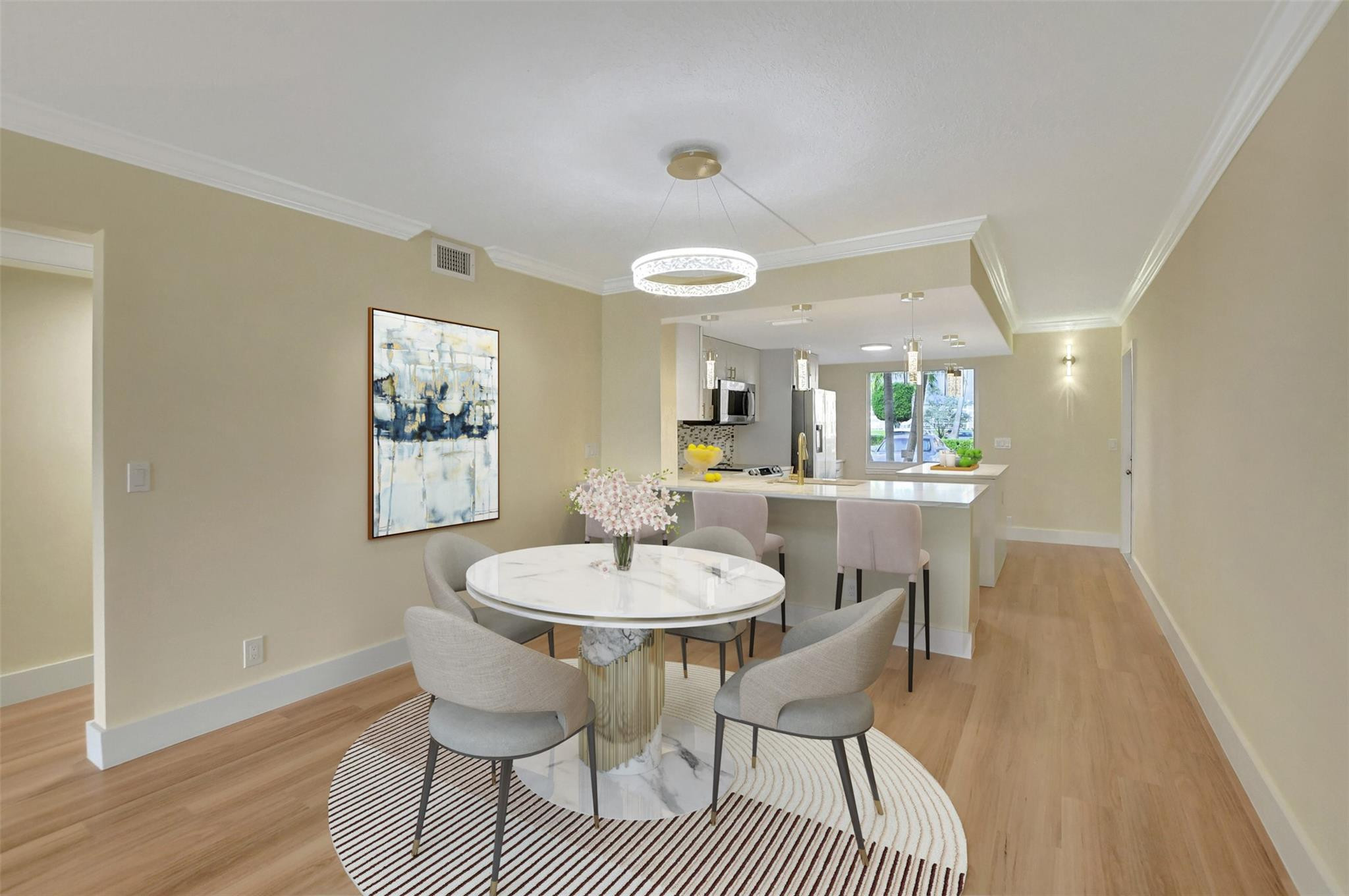 1019 Guildford East, Unit 1019 Boca Raton, FL 33434 - Photo 17 of 38 a dining room with furniture a rug and a chandelier