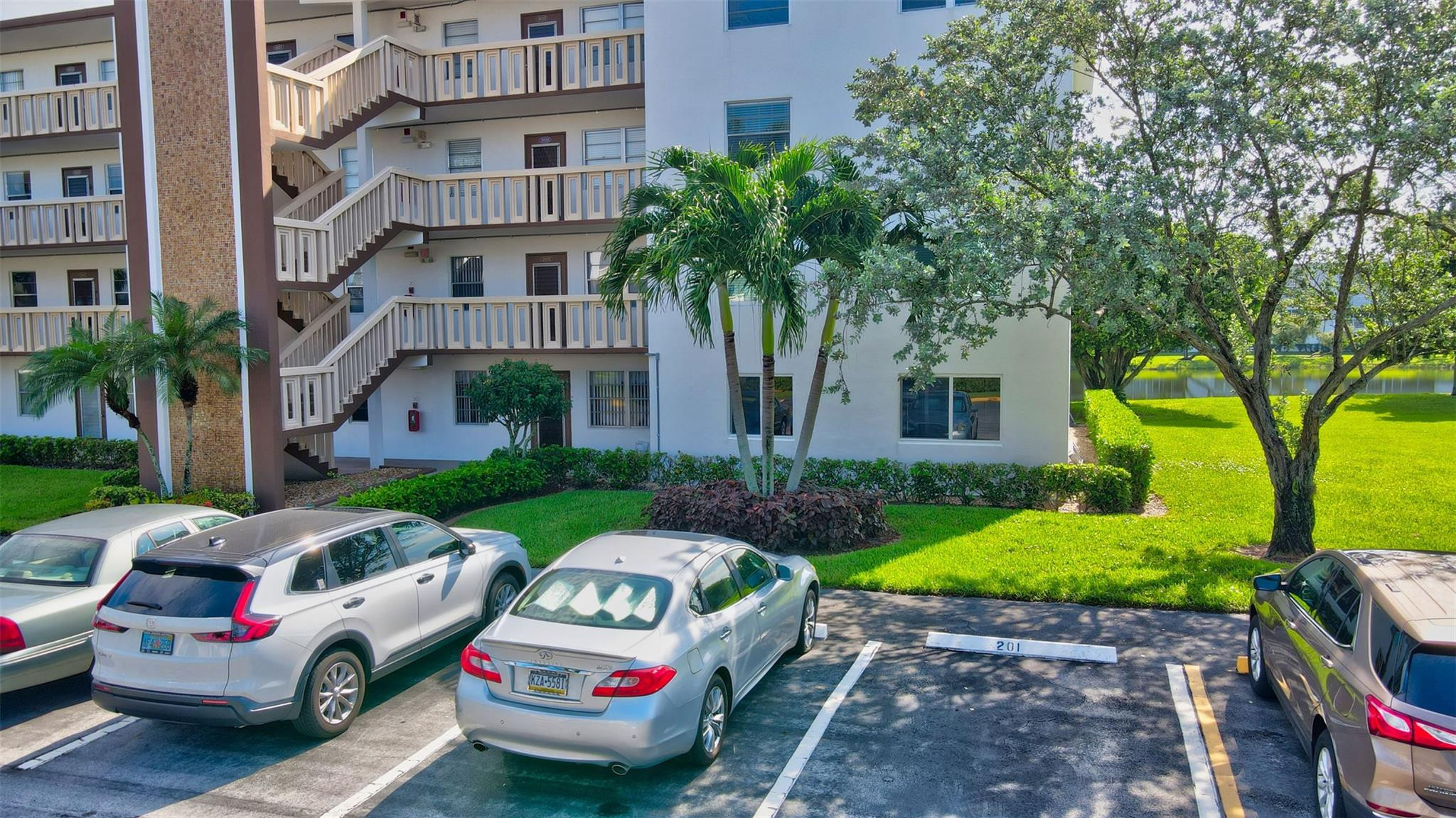 1019 Guildford East, Unit 1019 Boca Raton, FL 33434 - Photo 2 of 38 a front view of a house with garden