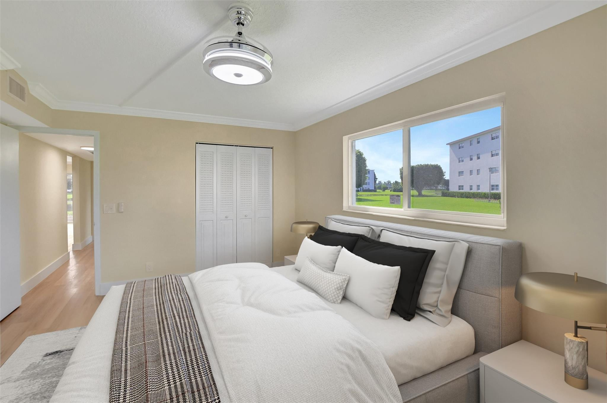 1019 Guildford East, Unit 1019 Boca Raton, FL 33434 - Photo 25 of 38 a bedroom with a bed and a painting on the wall