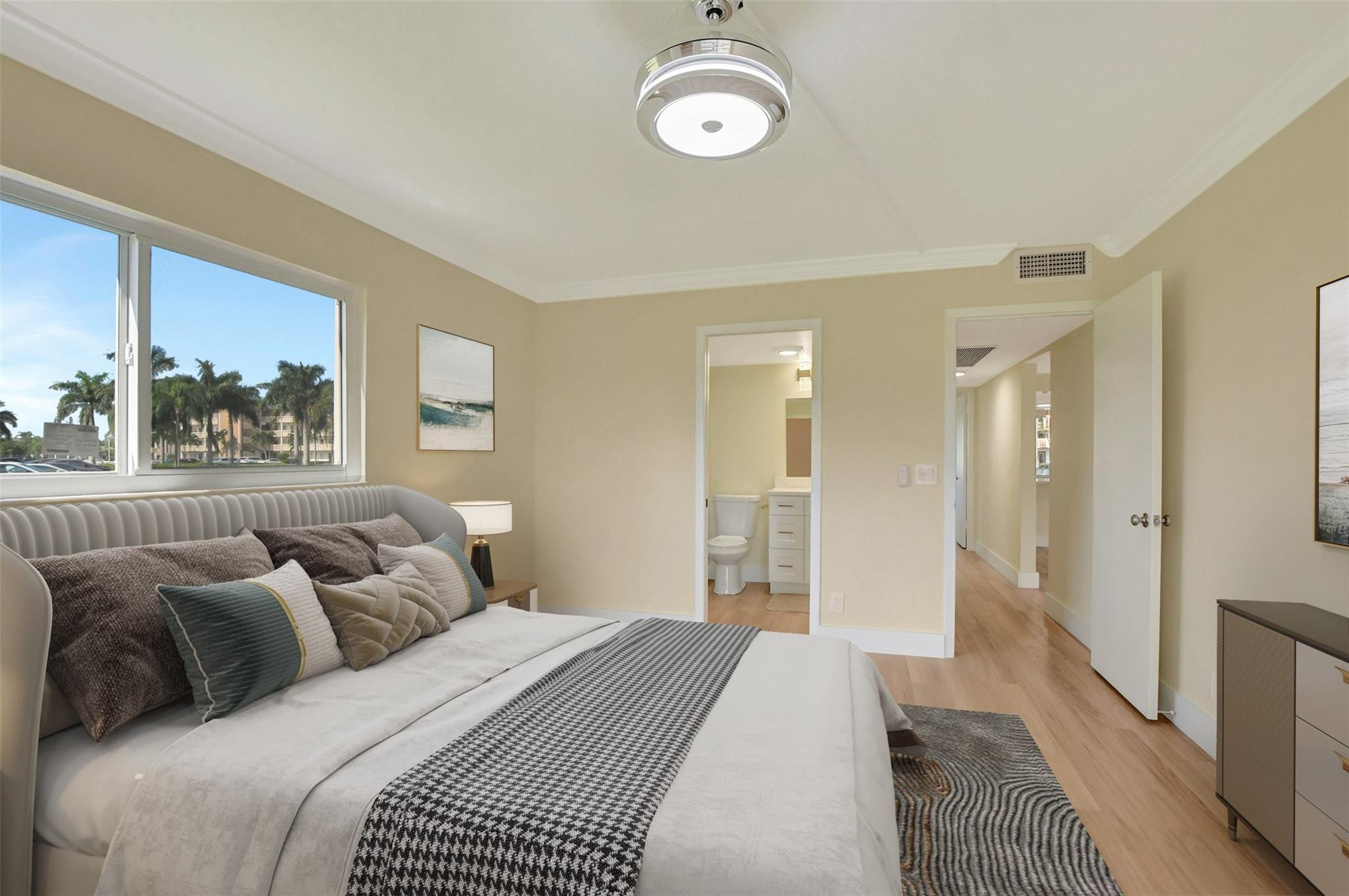 1019 Guildford East, Unit 1019 Boca Raton, FL 33434 - Photo 28 of 38 a bedroom with a large bed and a window