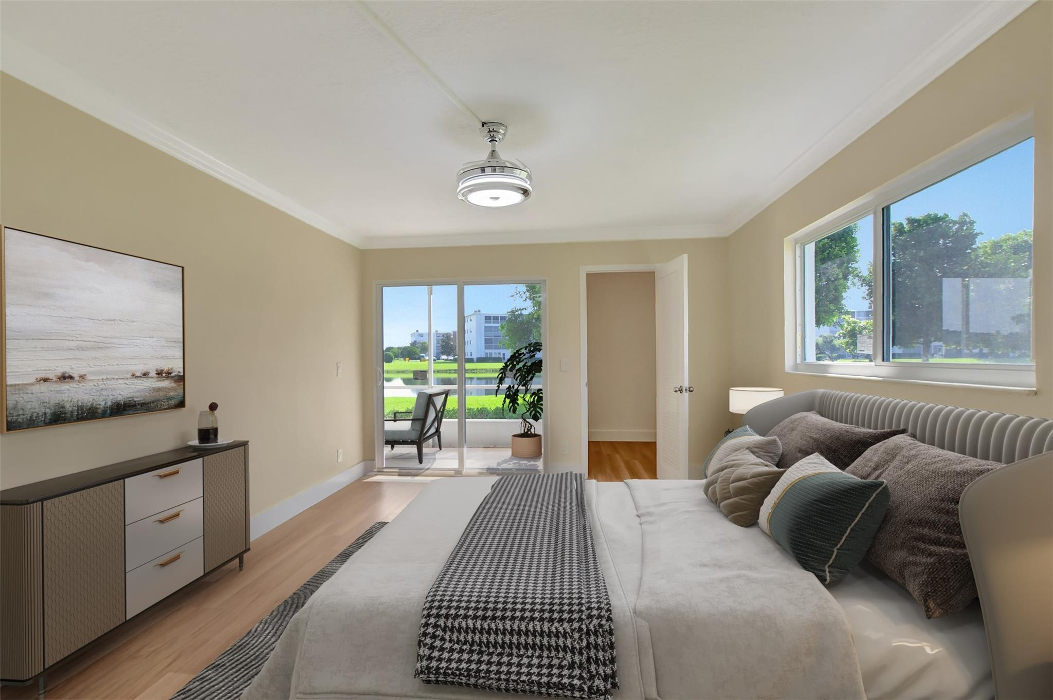 1019 Guildford East, Unit 1019 Boca Raton, FL 33434 - Photo 29 of 38 a bedroom with a bed and wooden floor
