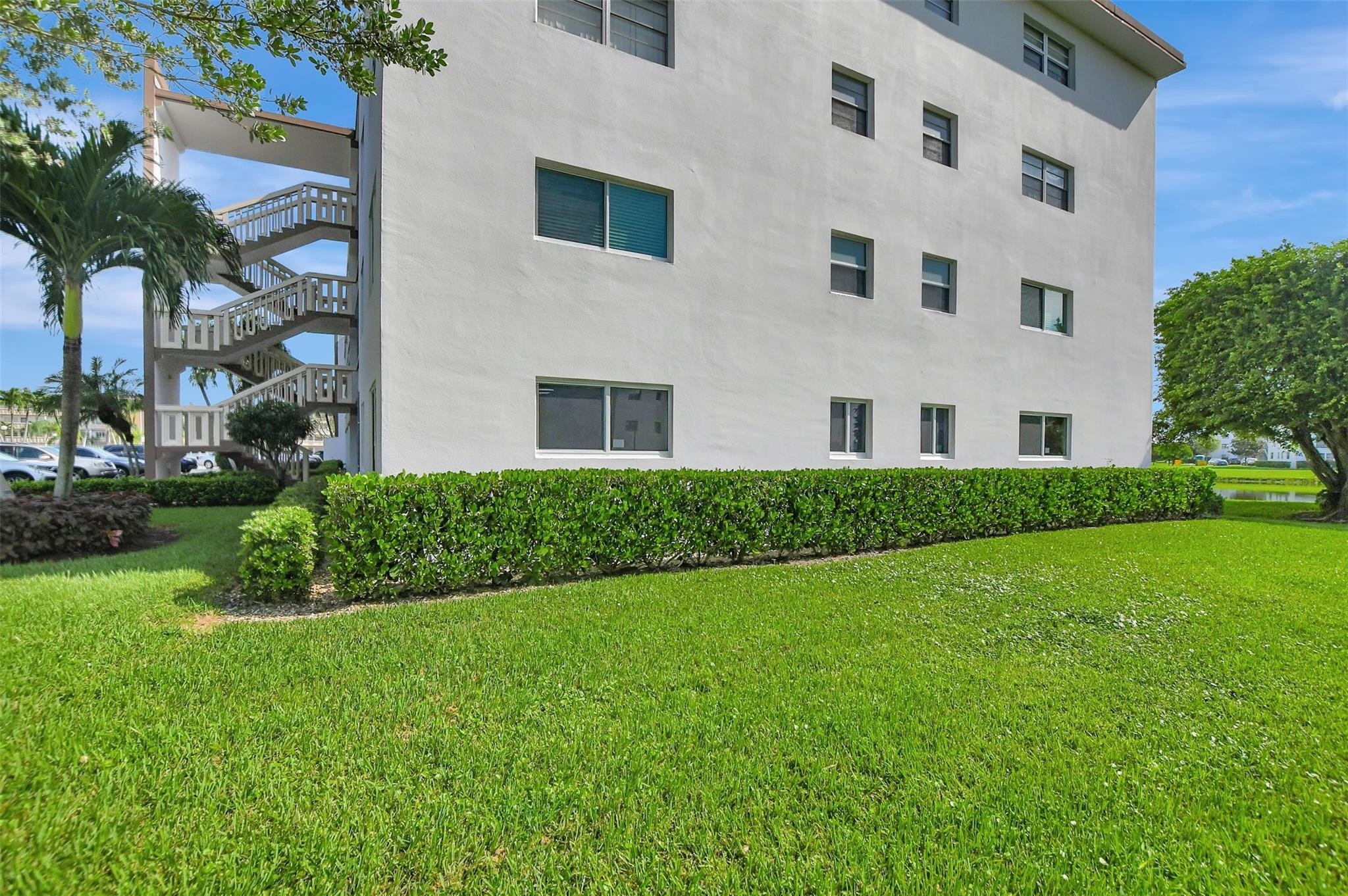 1019 Guildford East, Unit 1019 Boca Raton, FL 33434 - Photo 35 of 38 a front view of a house with a garden