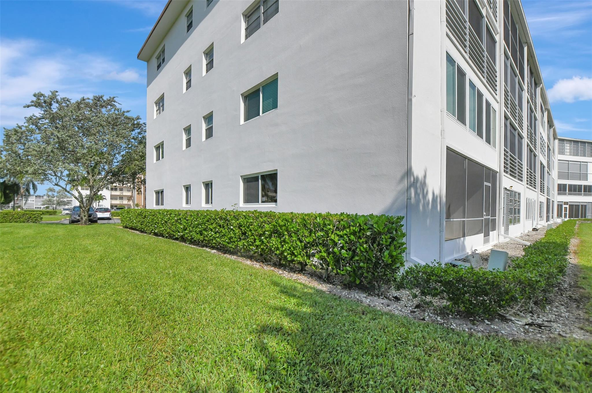 1019 Guildford East, Unit 1019 Boca Raton, FL 33434 - Photo 36 of 38 a view of an house with backyard space and garden