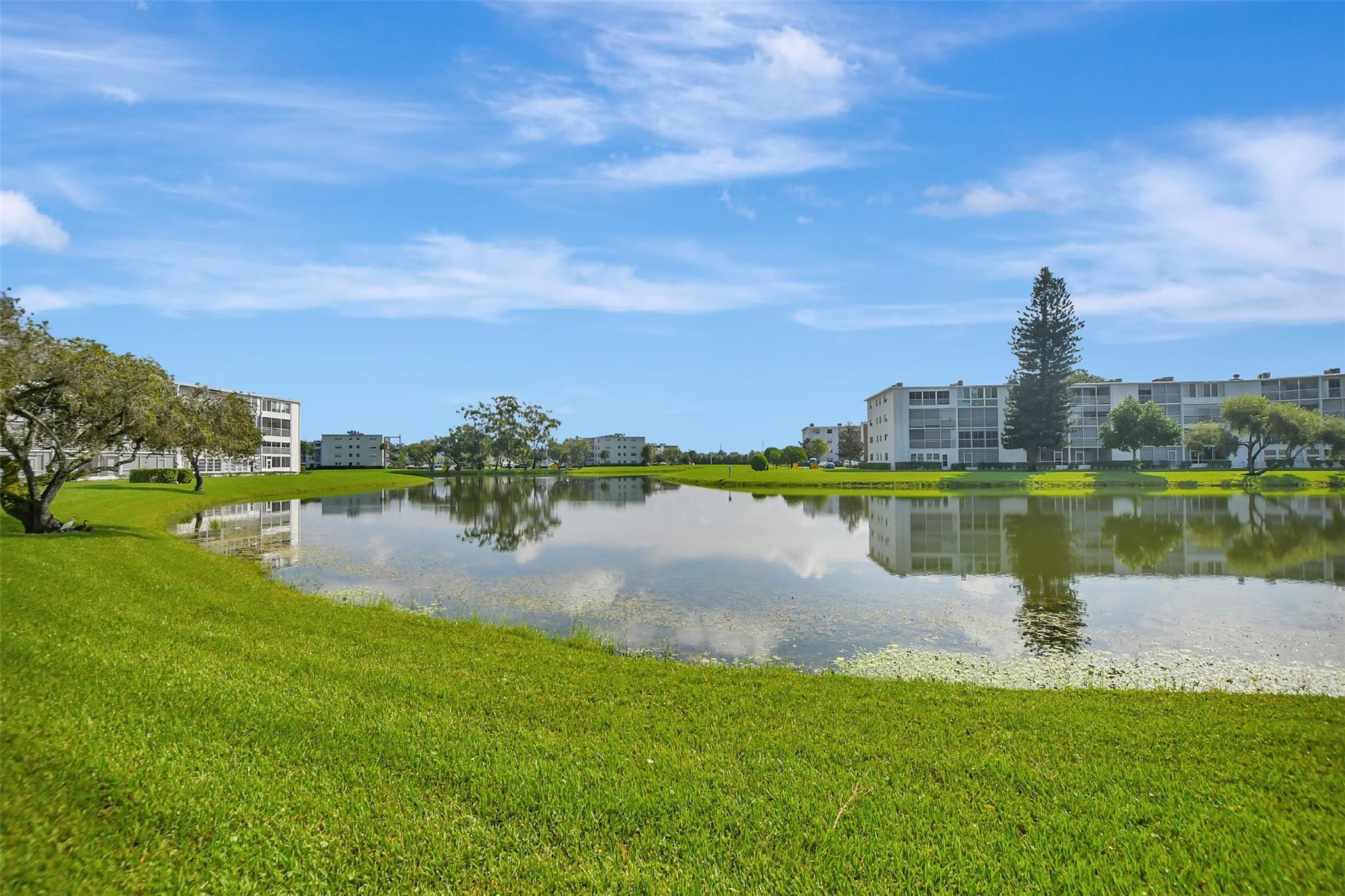 1019 Guildford East, Unit 1019 Boca Raton, FL 33434 - Photo 37 of 38 a view of a lake with a city