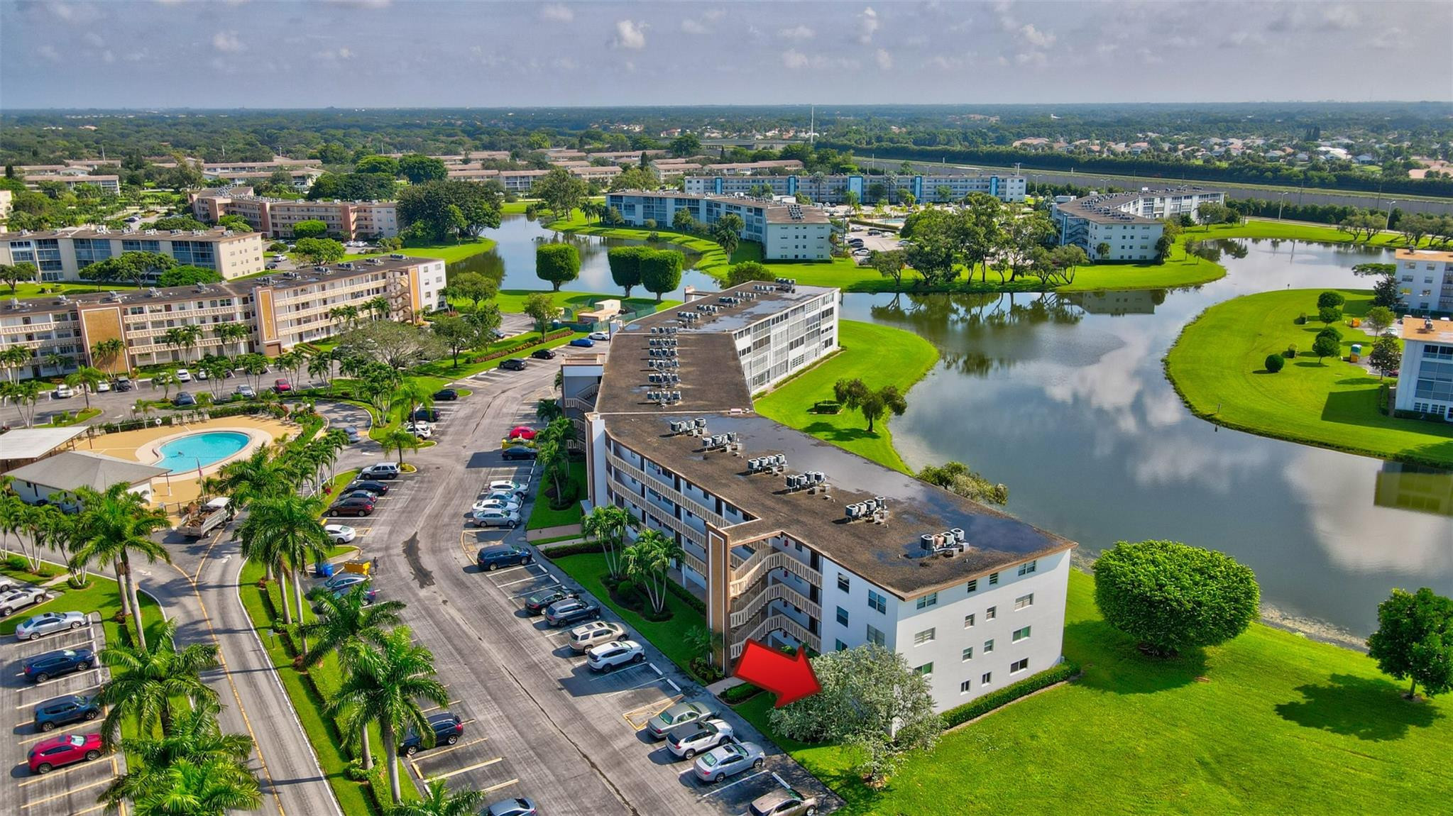 1019 Guildford East, Unit 1019 Boca Raton, FL 33434 - Photo 6 of 38 an aerial view of a house with a swimming pool yard and outdoor seating