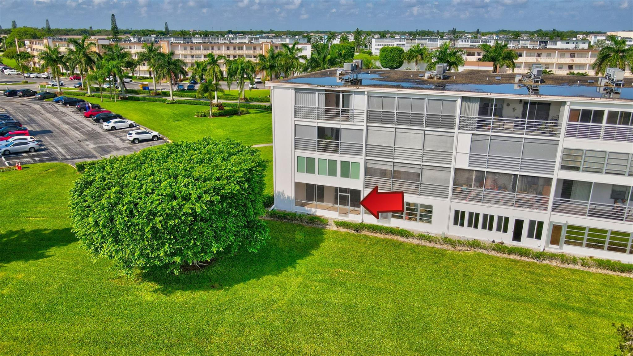 1019 Guildford East, Unit 1019 Boca Raton, FL 33434 - Photo 10 of 38 a view of a big yard with a large tree and a yard