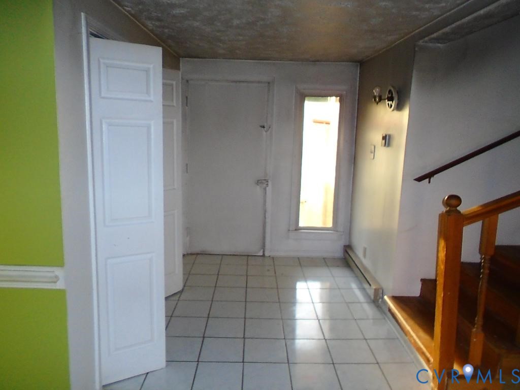16203 West Patrick Henry Road Montpelier, VA 23192 - Photo 7 of 23 Entryway featuring white square floor tiles, a woo