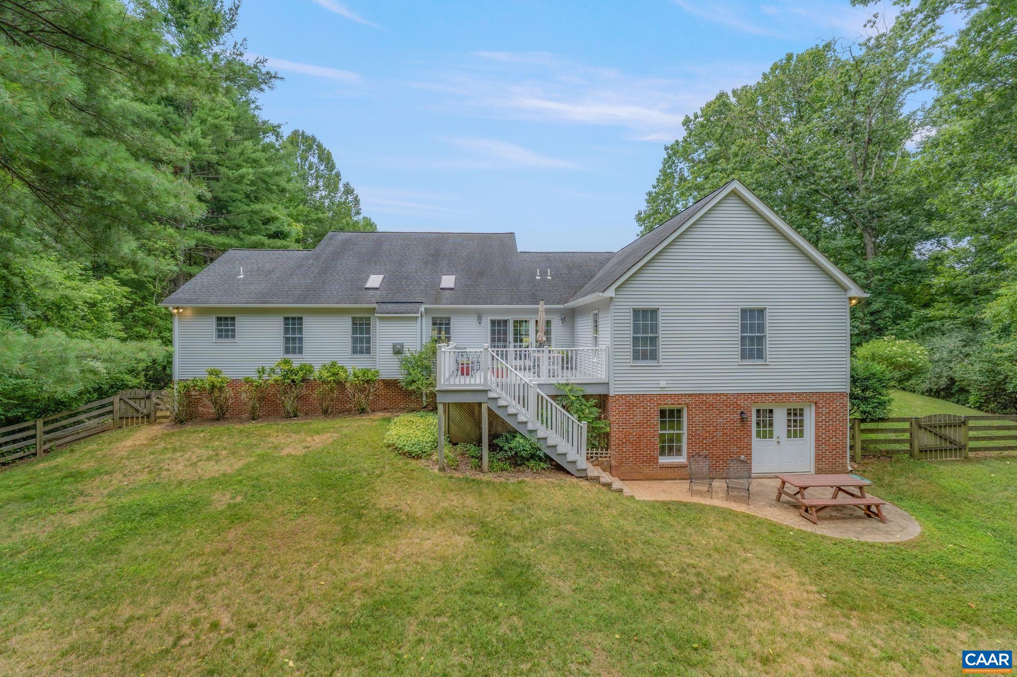 1900 Fray Road Advance Mills, VA 22968 - Photo 12 of 59 a front view of a house with a yard table and chairs