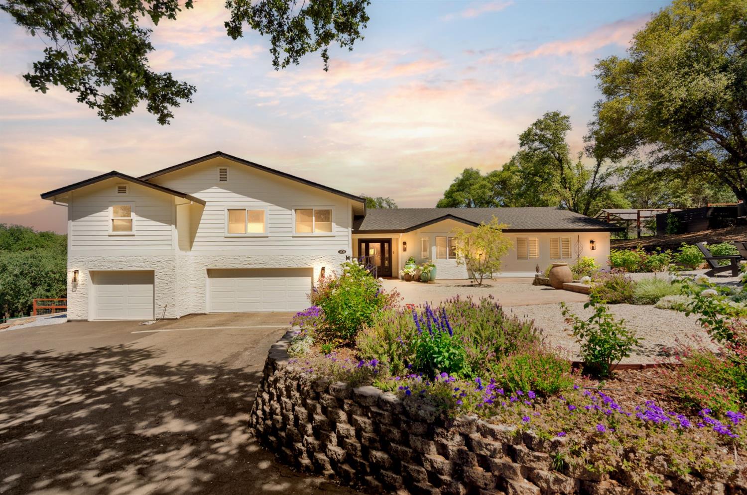 a front view of house with yard and trees around