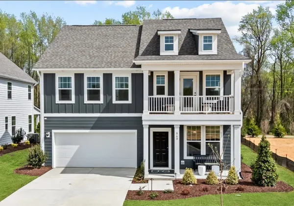 a front view of a house with garden and porch