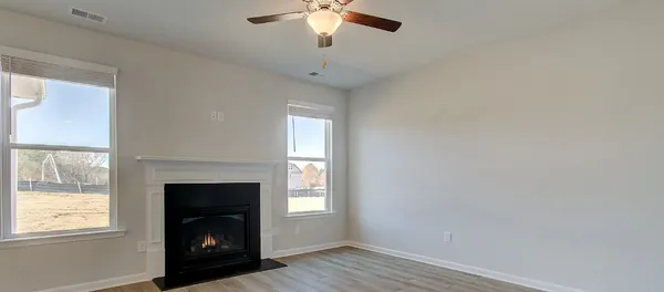 a living room with a fireplace and a window