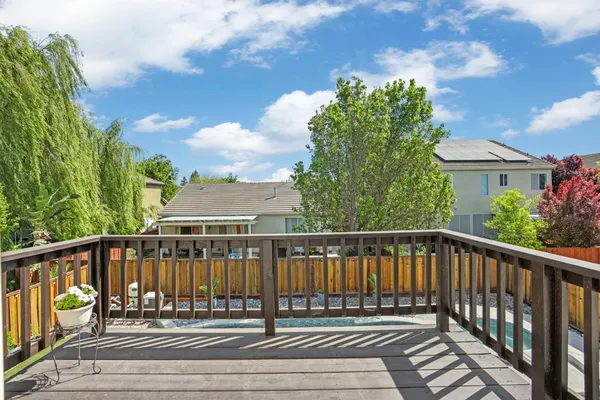 a view of a backyard with couches with wooden floor