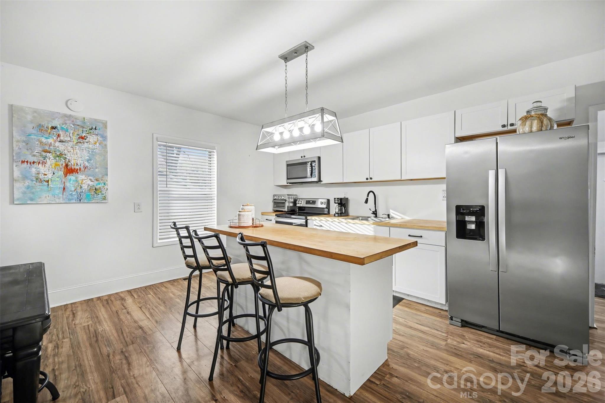 918 8th Street Lancaster, SC 29720 - Photo 17 of 32 a kitchen with stainless steel appliances granite countertop a dining table chairs sink and cabinets