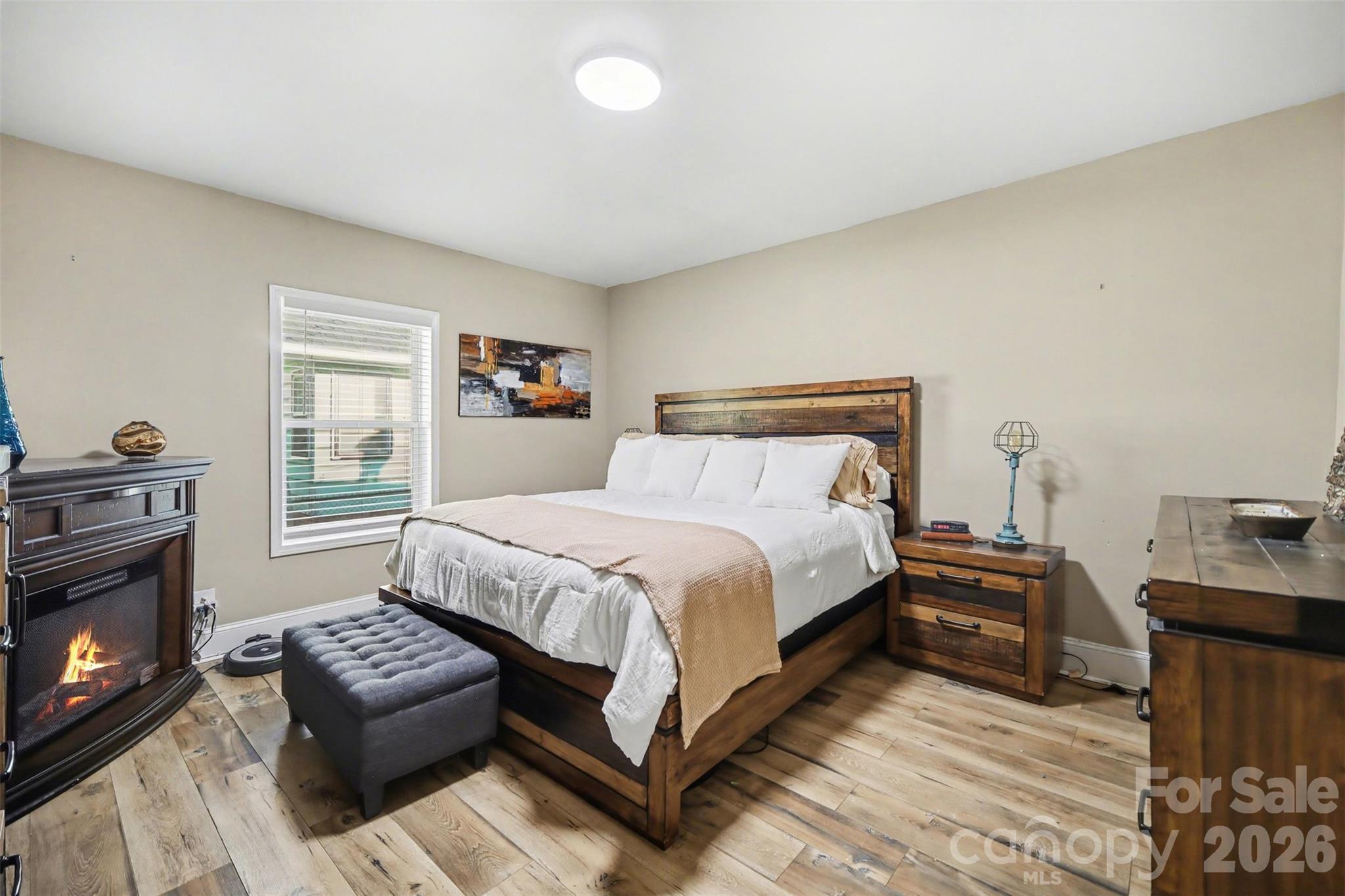 918 8th Street Lancaster, SC 29720 - Photo 5 of 32 a bedroom with a bed a fireplace and a television