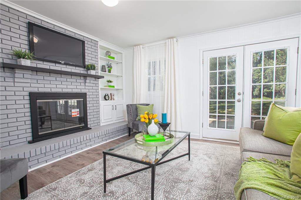 3607 Round Oak Road Charlotte, NC 28210 - Photo 11 of 36 a living room with furniture a flat screen tv and a fireplace