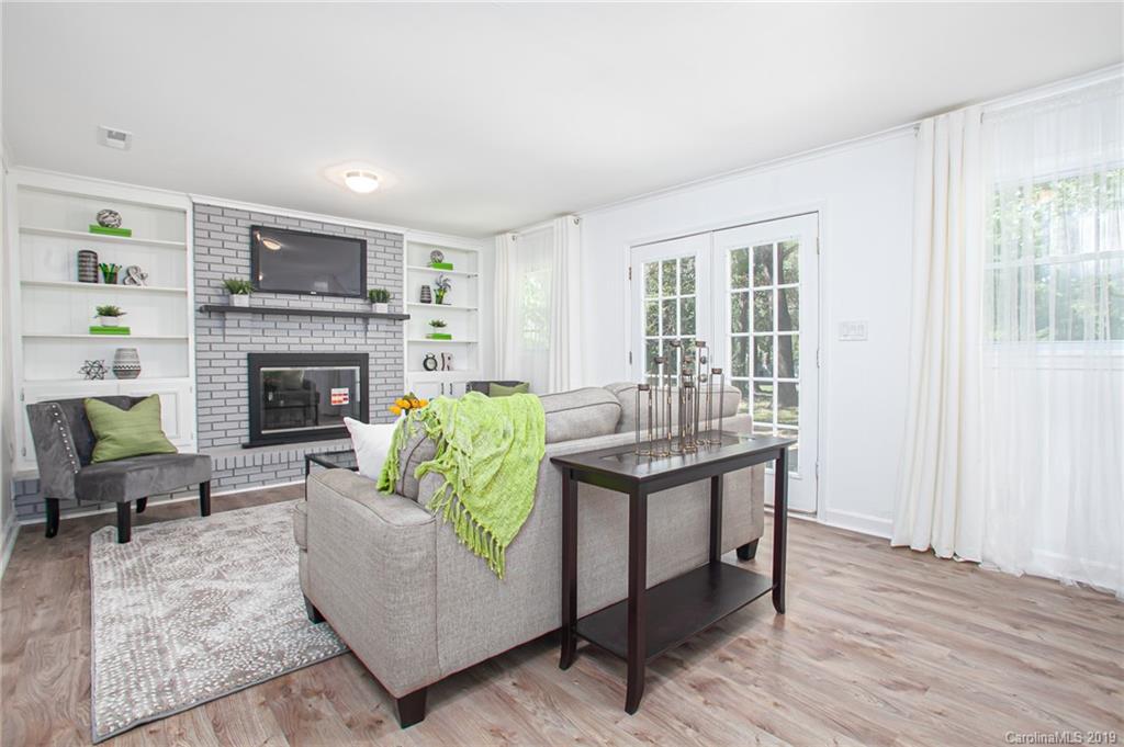 3607 Round Oak Road Charlotte, NC 28210 - Photo 13 of 36 a living room with furniture and a fireplace