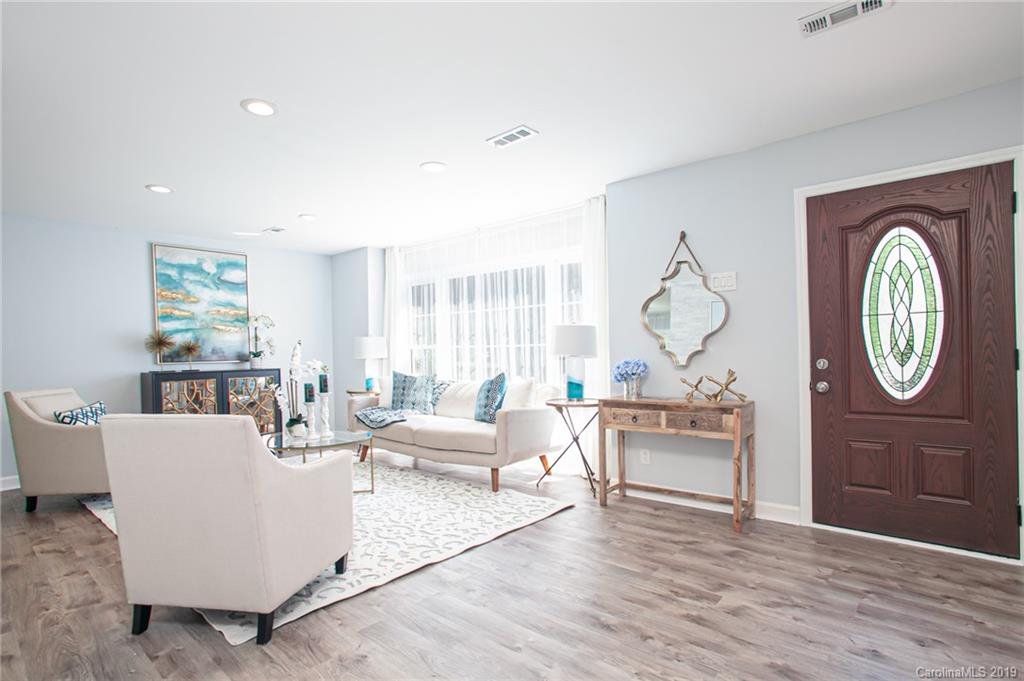 3607 Round Oak Road Charlotte, NC 28210 - Photo 16 of 36 a living room with furniture a large window and wooden floor
