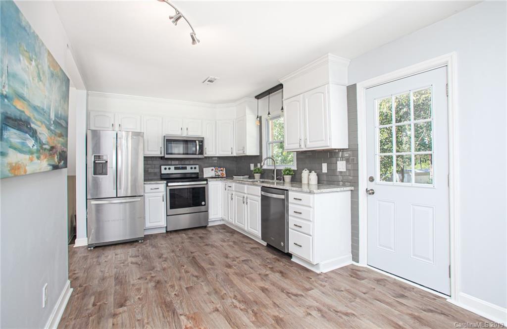 3607 Round Oak Road Charlotte, NC 28210 - Photo 19 of 36 a kitchen with granite countertop white cabinets and stainless steel appliances